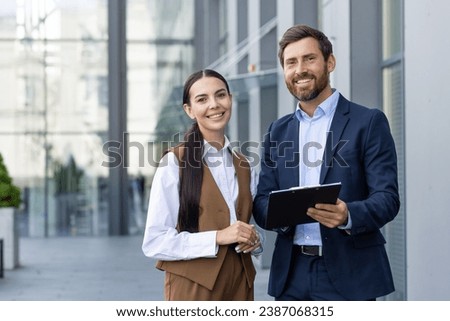 Similar – Image, Stock Photo Smiling businesswoman standing near gray wall