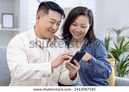 Similar – Image, Stock Photo Couple using smartphone together on bench