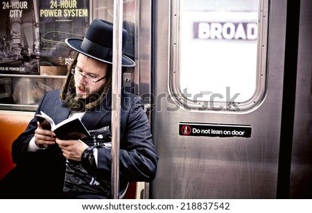 NEW YORK. USA - AUGUST 21, 2012: Jewish man reading Hebrew Bible in subway on August 21, 2012, in New York, USA