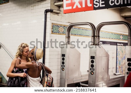 NEW YORK, USA - AUGUST 13, 2013: Young couple kissing on metro station in New York on August 13, 2013, USA