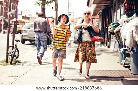 NEW YORK. USA - AUGUST 21, 2012: Grandson and grandmother walking on the New York street on August 21, 2012, USA