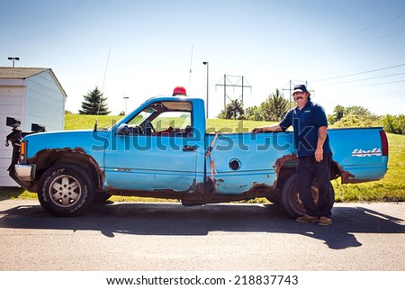 PENNSYLVANIA, USA - JULY 5, 2011: Man standing near old blue car in Pennsylvania on July 5, 2011, USA
