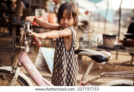 KAMPONG PHLUK,CAMBODIA - JANUARY 01: Portrait of an unidentified Khmer girl on Tonle Sap Lake in Kampong Phluk,Cambodia on 01.2014 January .It is the largest lake in Southeast Asia
