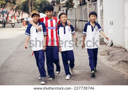 HO CHI MINH, VIETNAM - December 28,2013: Unidentied boys walking on street in Ho Chi Minh on December 28,2013, Vietnam