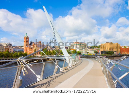 Urban skyline of Derry city (also called Londonderry) in northern Ireland with the famous "Peace Bridge" (Europe - Northern Ireland)
