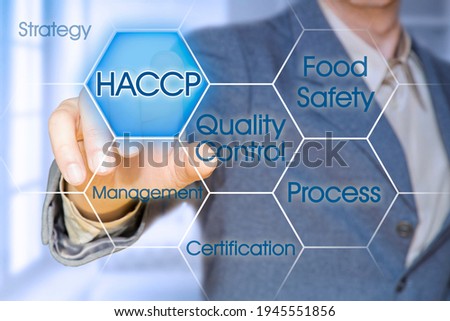HACCP (Hazard Analyses and Critical Control Points) - Food Safety and Quality Control in food industry concept with business manager pointing to icons against a digital display. Foto stock © 
