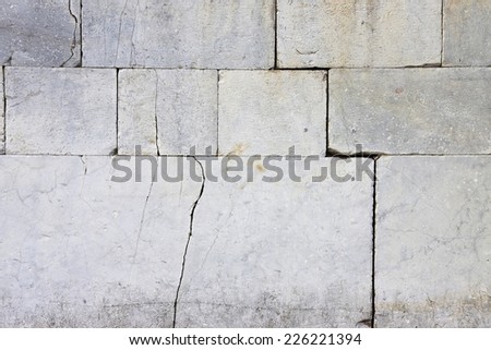 Cracked stone wall - lesion on a stone wall caused by subsidence of the foundation