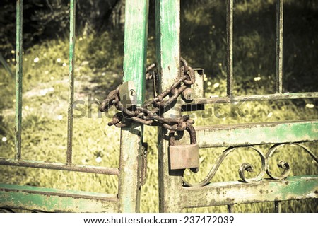 Metal gate closed with padlock - concept image