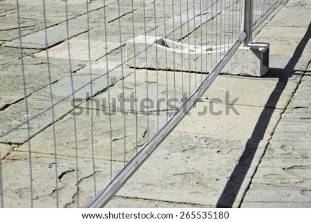 Metal barrier in a stone road - concept image