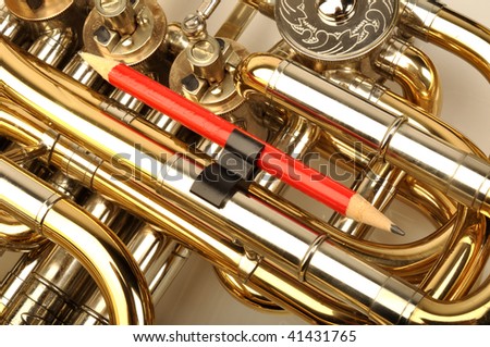 Detail of French Horn with red pencil on white background