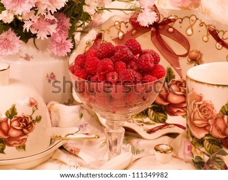 Vintage elegant teacups, raspberry and flowers