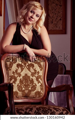 portrait of beautiful plus size young blond woman posing