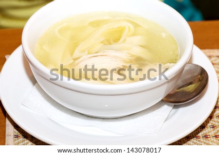 Tasty chicken clear soup with hen meat in plate