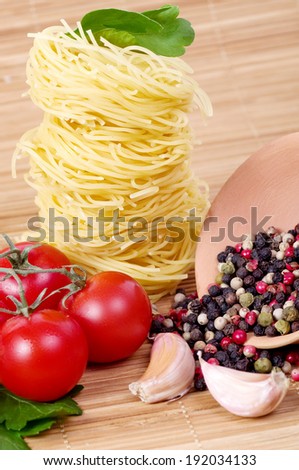 Italian raw pasta with tomatoes, cheese and spices