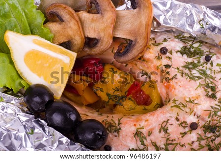 Pickled salmon with grilled vegetable, olive and lemon on a foil