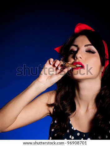 Vintage woman with cigar on dark background. Pin-up girl