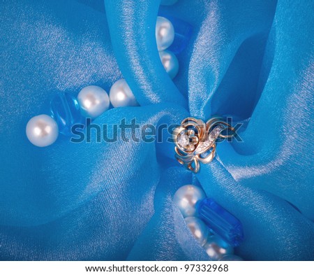 Golden jewelry ring on blue background