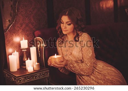 Portrait of beautiful young woman with candles
