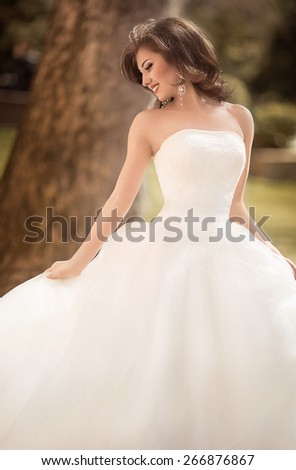 Beautiful bride with stylish make-up in white dress
