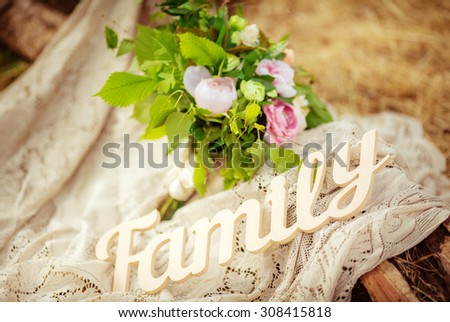 The word FAMILY written in wooden with flowers