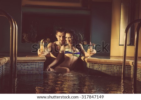 Romantic young couple in pool water lost in love