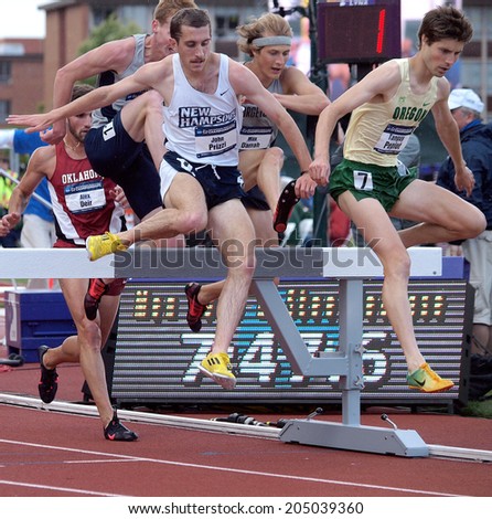 Eugene, Oregon June 12, 2014 - Tanguy Pepiot (R) of the University of Oregon and New Hampshire\'s John Prizzi clear the barrier in the men\'s 3000m steeplechase at the 2014 NCAA T&F Championships