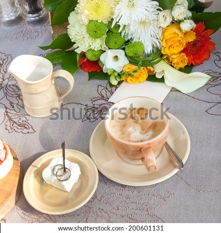 Wedding rings, coffee and sweets