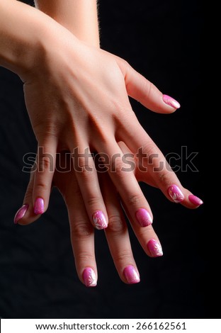 nails painted with shades of pink and white drawings