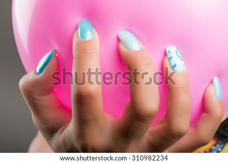 painted nails and pink balloon
