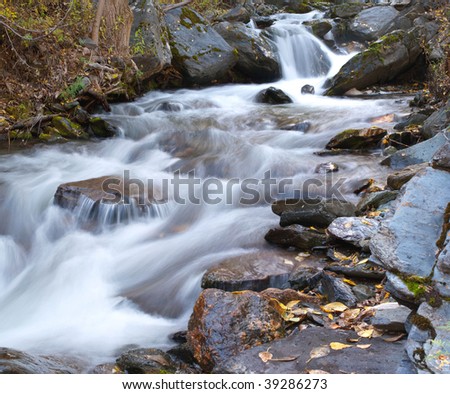 Rapid river stream and large stones.
