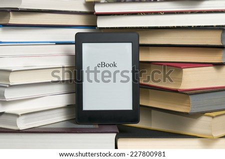 Electronic book shown versus several regular text books