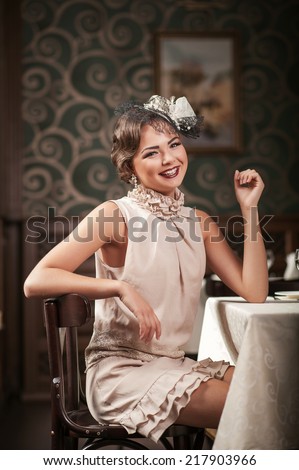 Beautiful girl sitting at a table at the Restaurant