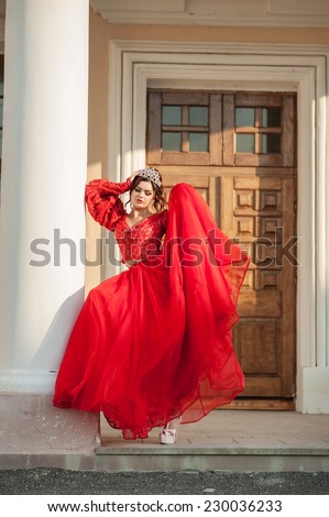 Beautiful girl posing near the old palace, dynamics, top-down