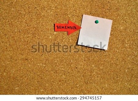 Reminder for an important date on a cork board. White notepad with copy space