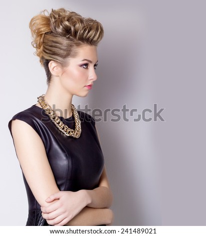 Beautiful young woman with evening make-up and salon hairdo . Smoky eyes. Complicated hairstyle for party