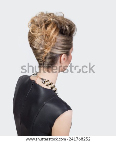 Beautiful woman with evening salon hairdo. Complicated hairstyle for party