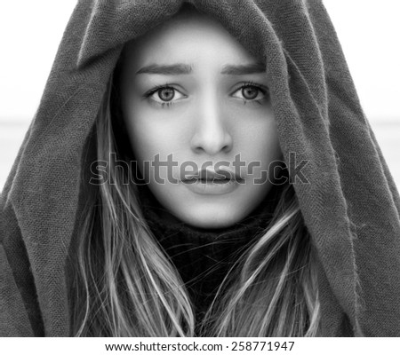 black and white portrait of a beautiful young girl with big eyes with a sad mood, sadness on her face with a scarf on her head, portrait, closeup, sad eyes