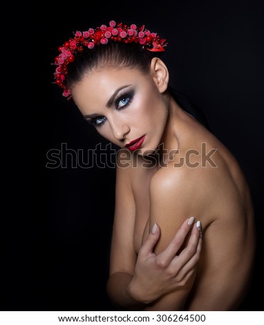 expensive jewelry wreath earrings and ring on a beautiful sexy nude elegant brunette girl with bared shoulders with bright evening make-up