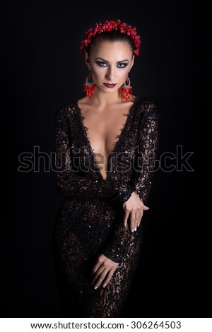 expensive jewelry wreath earrings and ring on a beautiful sexy elegant brunette girl with a bright evening make-up in a black evening dress with lace