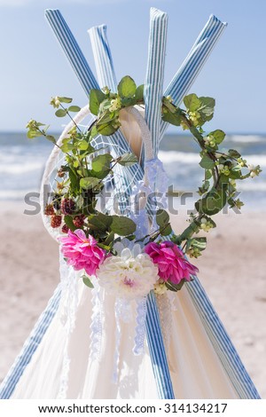 beautiful wedding vibrant color for the bride wreath hanging on a tent