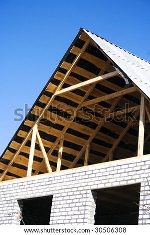 Building house with white brick against the blue sky. Building site