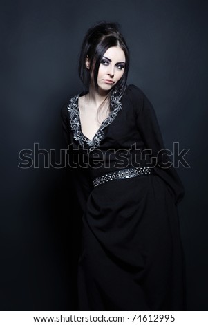 Portrait of a mystical woman in an elegant black dress