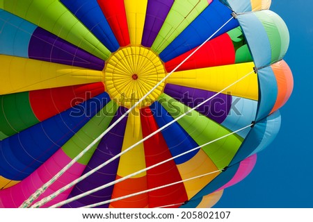 Beautiful vivid and vibrant colors of a hot air balloon. Exciting flying experience in the blue sky.