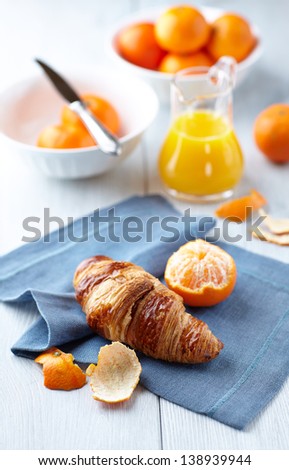 Croissant with mandarin oranges and orange juice