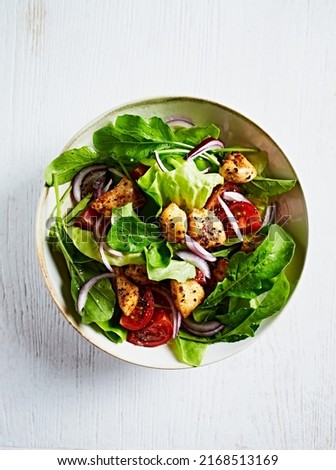 Chicken sald with cherry tomato, young arugula, lettuce and red onion Сток-фото © 