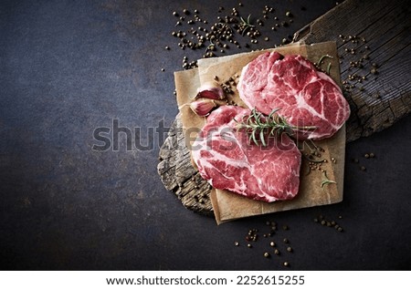 Similar – Foto Bild Rohes Schweinesteak auf einem Teller, Ansicht von oben. Steak isoliert auf blauem Hintergrund