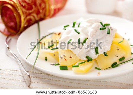 Potato salad with herring and sour cream for christmas