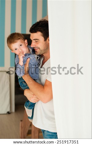 Dad and son standing near the wall and play