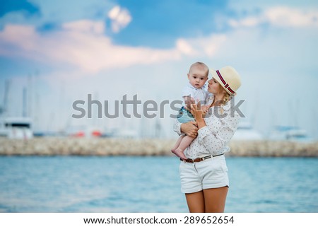 Mother and son hugging the beach, happy family, holidays