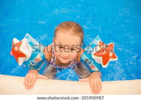 Funny child  in swimming pool. Summer vacation concept